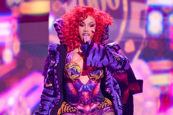 Cardi B performing at the 2026 BET Awards in a colorful bodysuit with fiery red hair