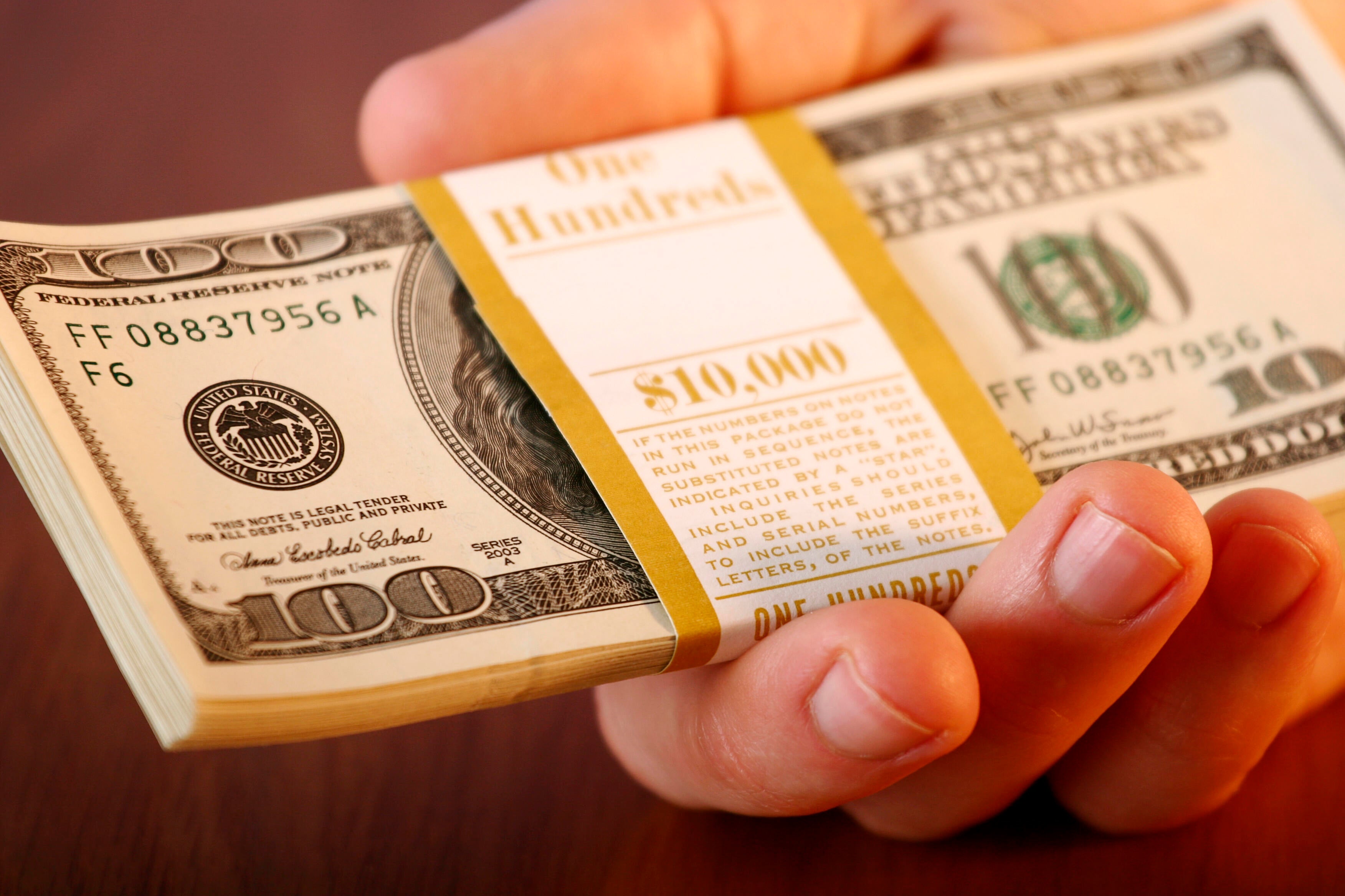 Calculator and bank documents representing the comparison between 1-year CD rates and high-yield savings account rates in July 2026