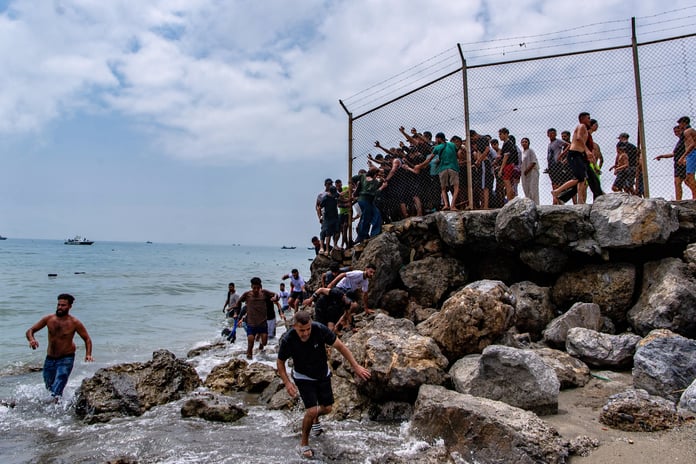 Migrants swimming to reach Spain's Ceuta enclave from Morocco on July 30, 2026