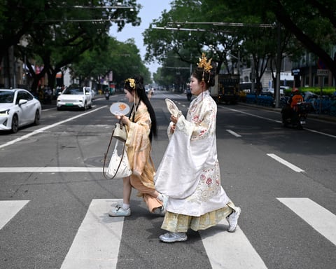 Members of an ethnic minority group in China's Xinjiang region, where Beijing's new ethnic unity law mandates Mandarin as the sole language of instruction from kindergarten