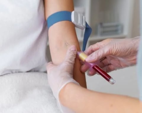 Healthcare professional reviewing a patient's cholesterol blood test results to assess cardiovascular risk and determine whether statin therapy is appropriate.