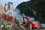Rescue workers searching through rubble from Chongqing landslide in Pengshui County