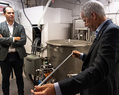 US Energy Secretary Chris Wright holds a fuel rod at Idaho National Laboratory during the Unity microreactor criticality demonstration by Deployable Energy
