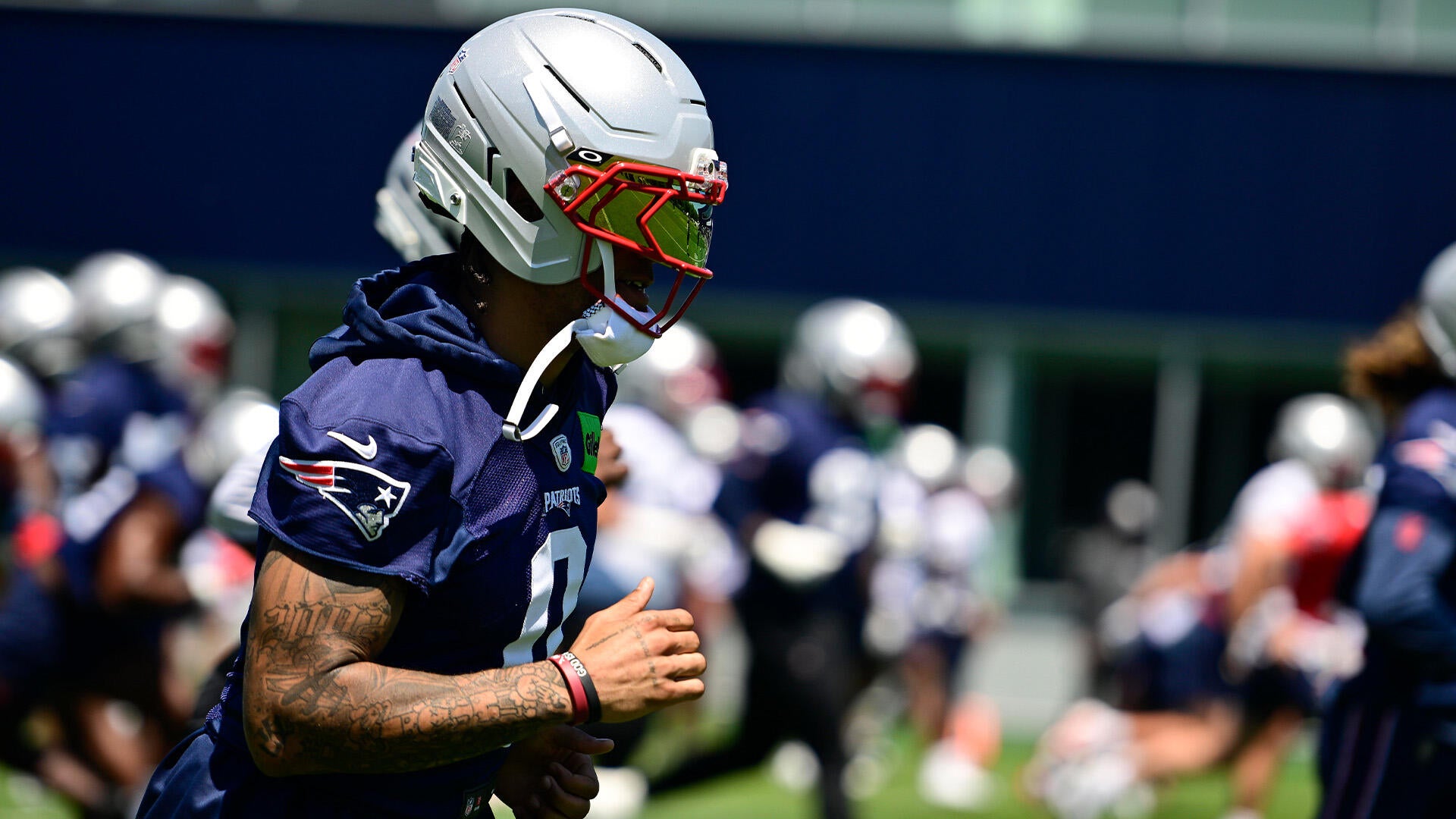 Christian Gonzalez in New England Patriots jersey and helmet at 2026 training camp