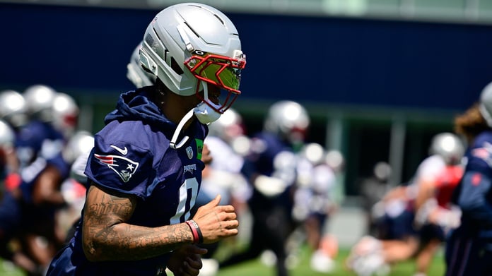 Christian Gonzalez in New England Patriots jersey and helmet at 2026 training camp