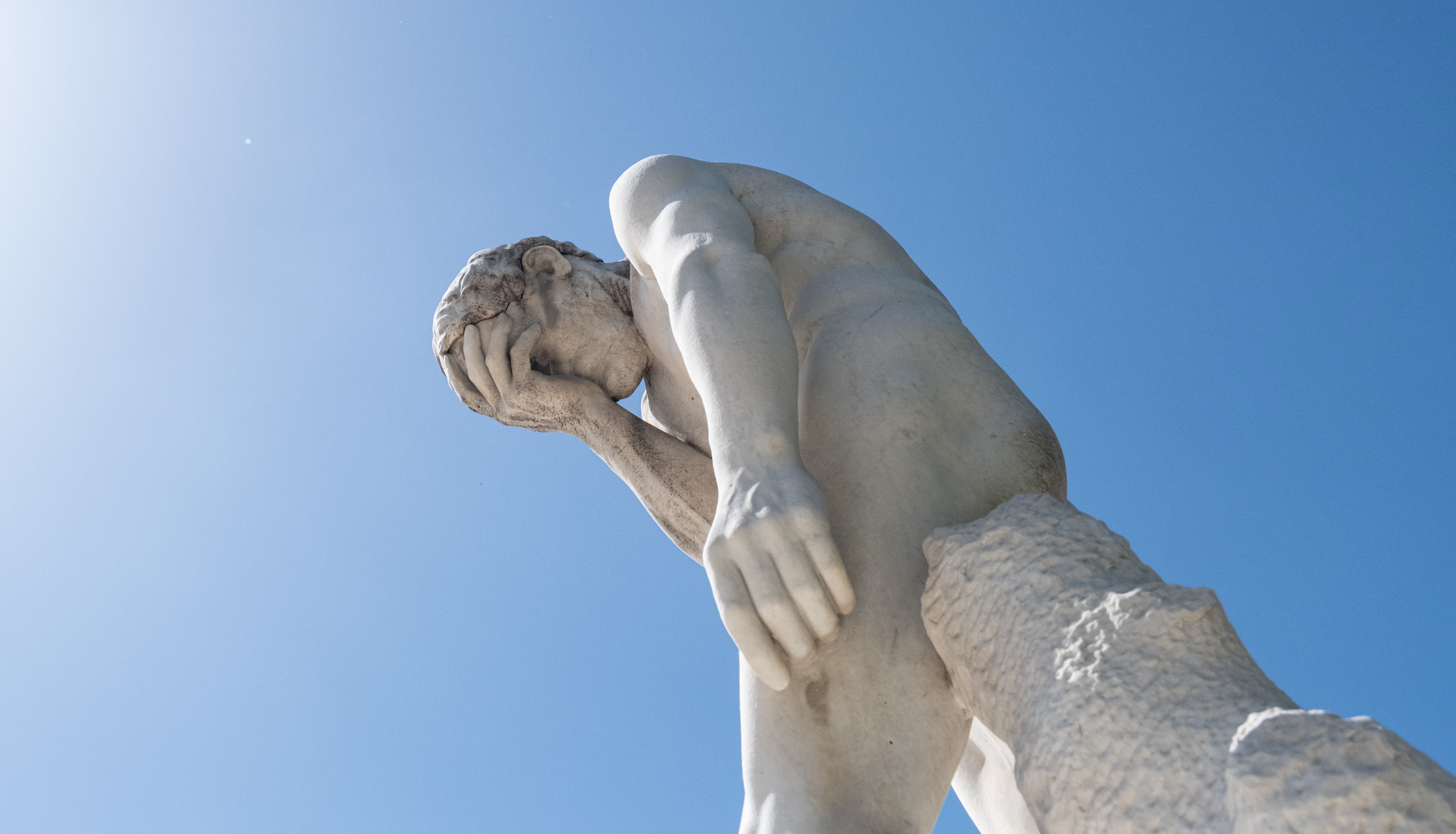 Facepalm statue representing Anthropic Claude AI privacy failure and Google indexing of shared conversations