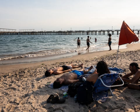 Beachgoers crowd Coney Island in New York City seeking relief from the record heat wave affecting the Eastern United States, July 2026