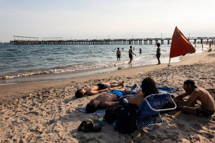 Beachgoers crowd Coney Island in New York City seeking relief from the record heat wave affecting the Eastern United States, July 2026