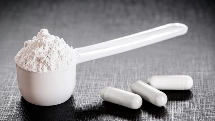 Creatine supplement powder in a container, long used by athletes and now studied for depression