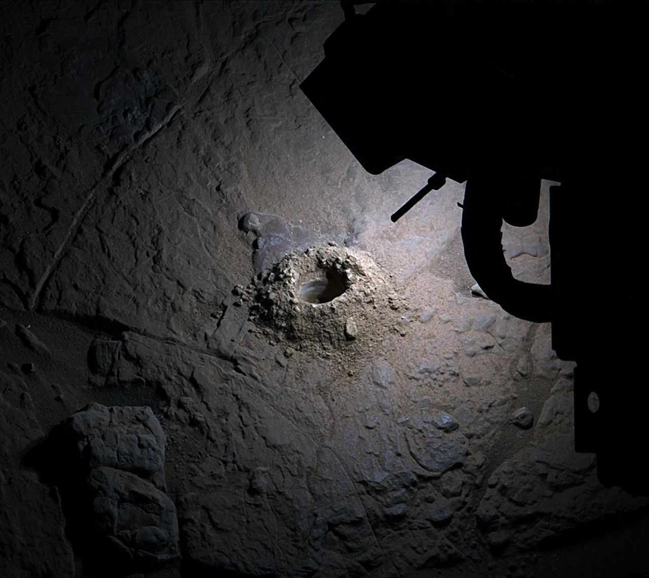 NASA Curiosity rover illuminates rock samples at night near the Nevado Sajama drill site on Mars