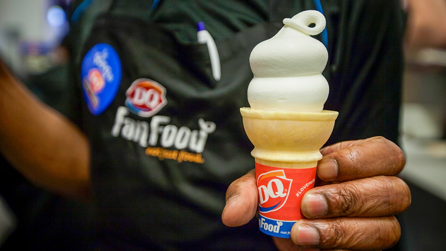 Dairy Queen employee serving an ice cream cone as the chain closes over 46 locations across Texas, Alaska, and Montana