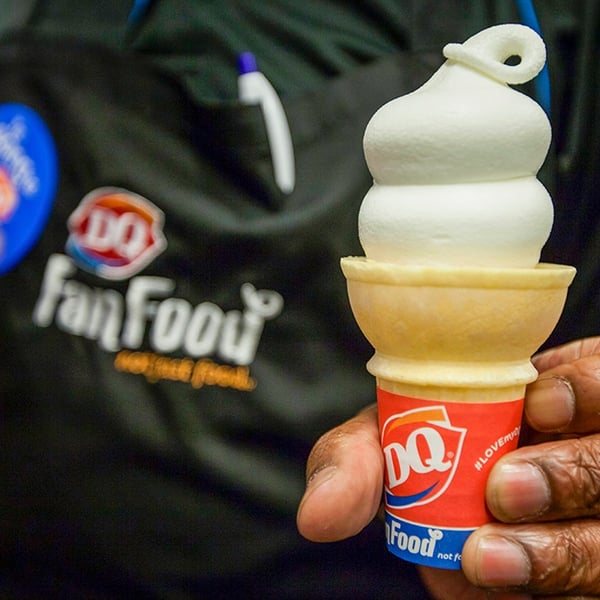 Dairy Queen employee serving an ice cream cone as the chain closes over 46 locations across Texas, Alaska, and Montana