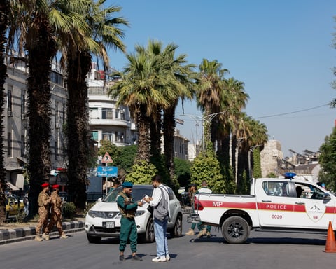 A police vehicle parked near the site of the bomb blast at a cafe on al-Nasser Street in central Damascus, Syria, July 2, 2026