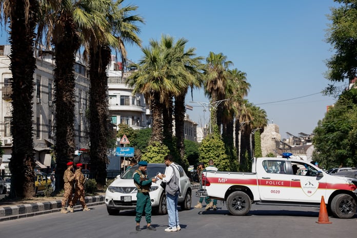 A police vehicle parked near the site of the bomb blast at a cafe on al-Nasser Street in central Damascus, Syria, July 2, 2026
