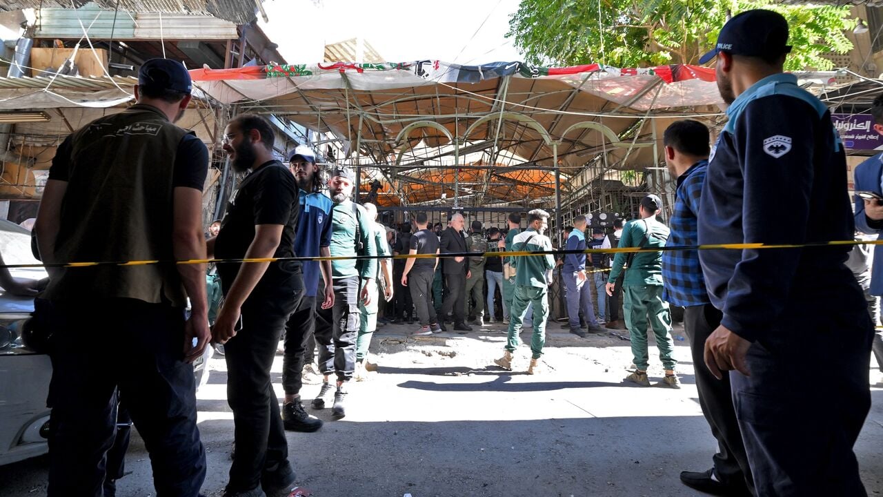 Syrian security forces and civilians gather at the site of the cafe explosion on al-Nasser Street in central Damascus, Syria, July 2, 2026