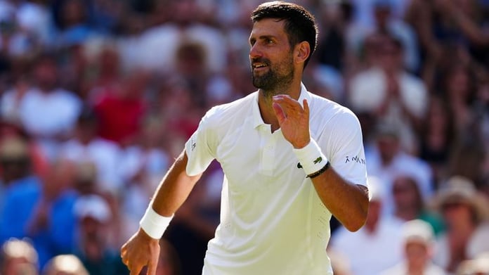 Novak Djokovic on Centre Court at Wimbledon 2026, celebrating after equaling Roger Federer's all-time record of 105 men's wins