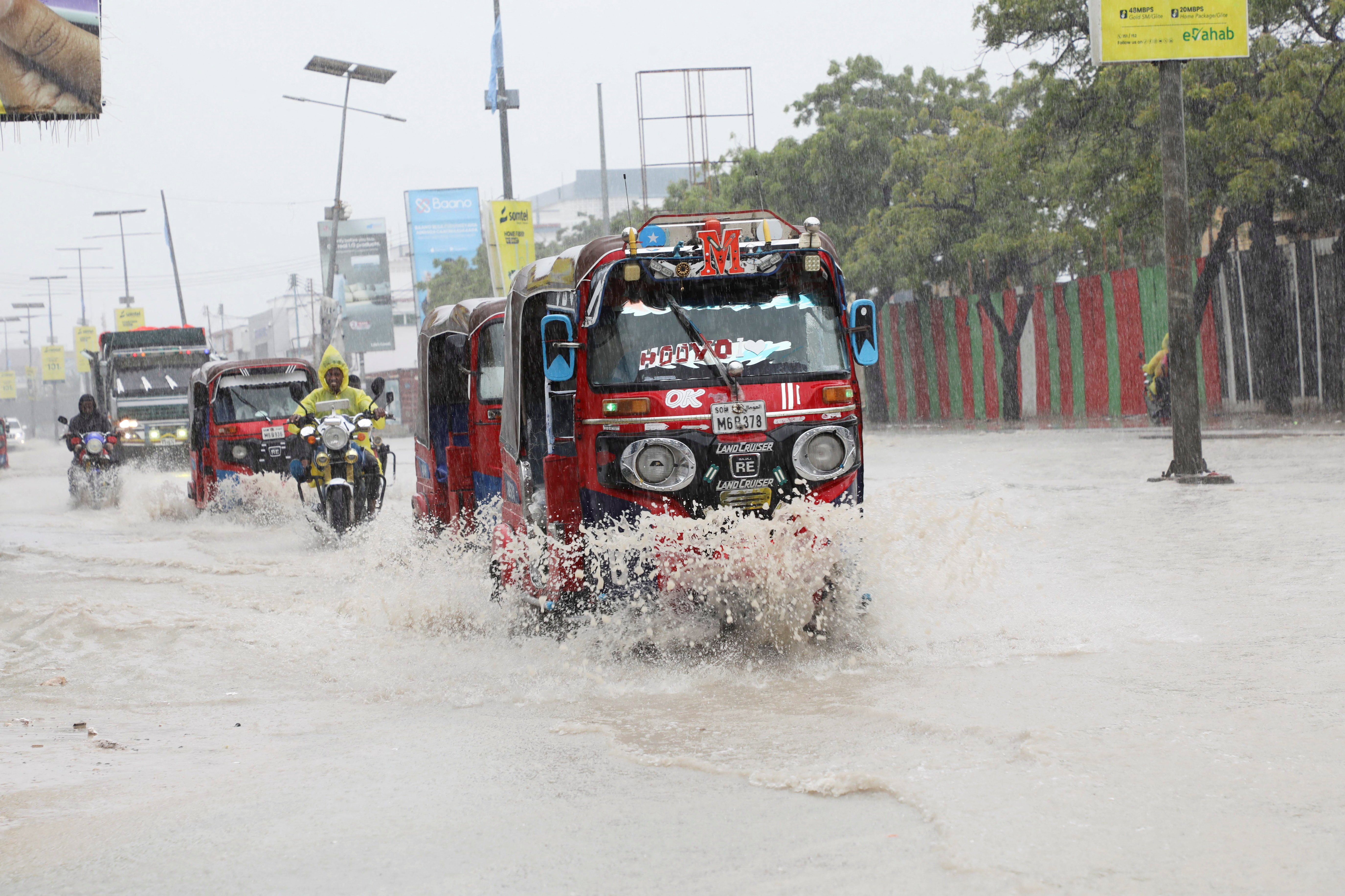 Tuktuks navigate floodwater on KM4 street in Mogadishu Somalia during El Nino flooding 2026