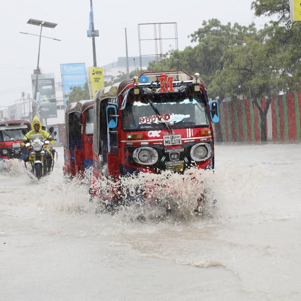 Tuktuks navigate floodwater on KM4 street in Mogadishu Somalia during El Nino flooding 2026