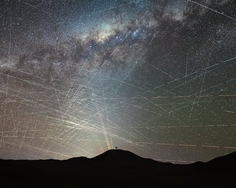 Time-lapse photograph showing satellite streaks crossing the night sky above ESO's Very Large Telescope in Chile's Atacama Desert