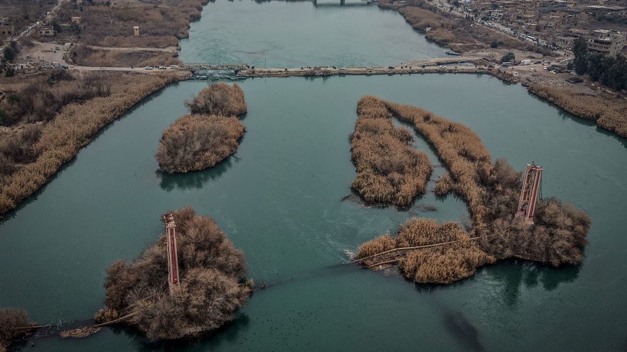Syrian Civil Defense rescue teams search the Euphrates River near Deir Ezzor after ferry hits bridge killing two children