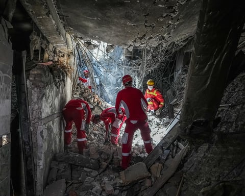 Rescue workers sift through rubble inside Evin Prison complex in Tehran after Israeli airstrike June 2025