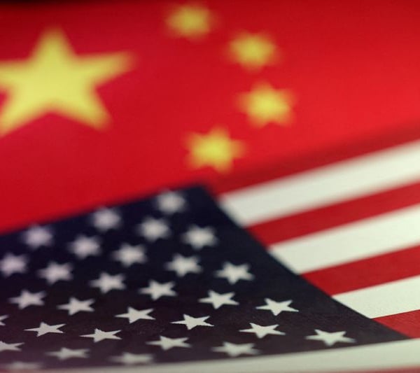 U.S. and Chinese flags illustration — FCC adds Chinese robots to national security Covered List