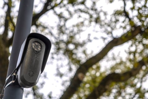 A Flock Safety automated license plate reader camera mounted on a pole in Houston, Texas