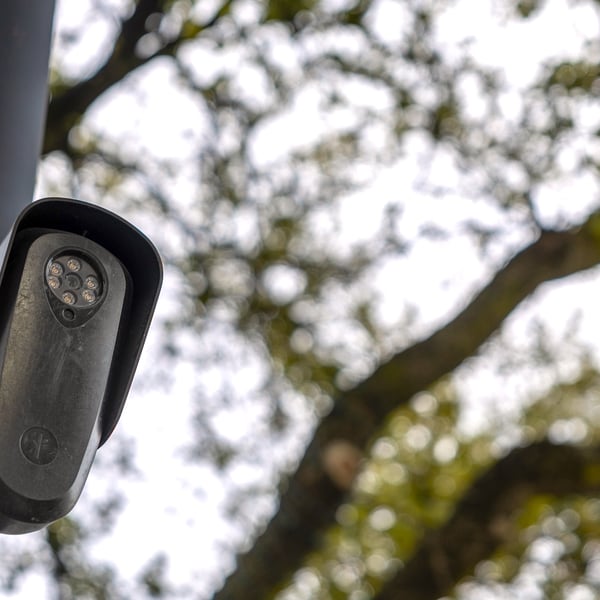 A Flock Safety automated license plate reader camera mounted on a pole in Houston, Texas