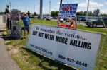 A protester holds a sign against the death penalty outside a federal prison in Terre Haute, Indiana