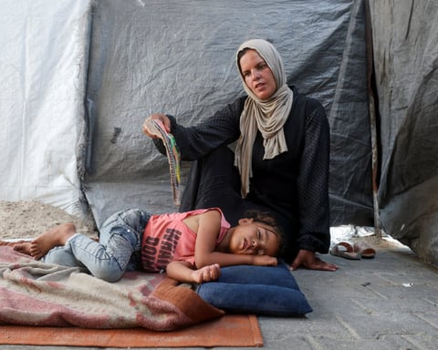 Displaced Palestinians sheltering at a school in Khan Younis as Gaza marks 1000 days of war