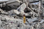 A Palestinian child stands on rubble of a destroyed building near the Shati refugee camp in northern Gaza City, July 1, 2026