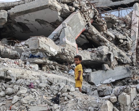 A Palestinian child stands on rubble of a destroyed building near the Shati refugee camp in northern Gaza City, July 1, 2026