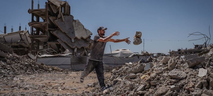 Man clearing rubble in Jabalia camp in northern Gaza, amid destruction from Israeli military operations in June 2026