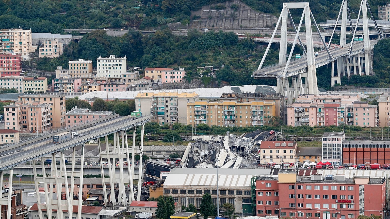 Emergency workers and wreckage at the site of the Morandi Bridge collapse in Genoa that killed 43 people in 2018