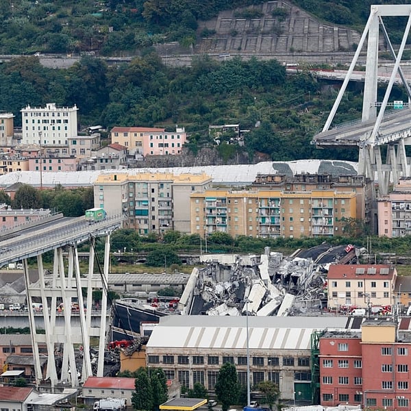 Emergency workers and wreckage at the site of the Morandi Bridge collapse in Genoa that killed 43 people in 2018