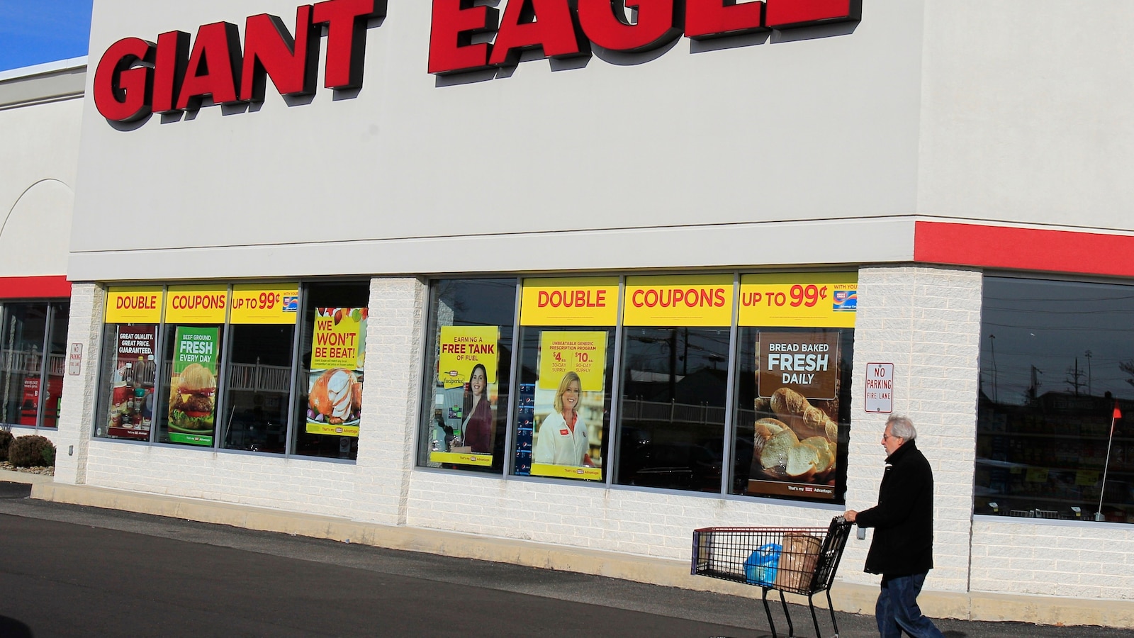 A customer walks out of a Giant Eagle grocery store, the chain Kroger is acquiring for 1.65 billion dollars