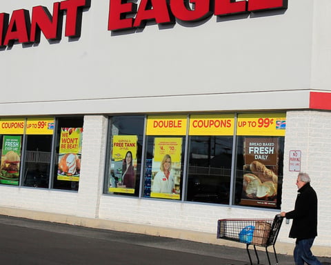 A customer walks out of a Giant Eagle grocery store, the chain Kroger is acquiring for 1.65 billion dollars