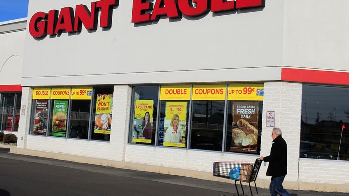A customer walks out of a Giant Eagle grocery store, the chain Kroger is acquiring for 1.65 billion dollars