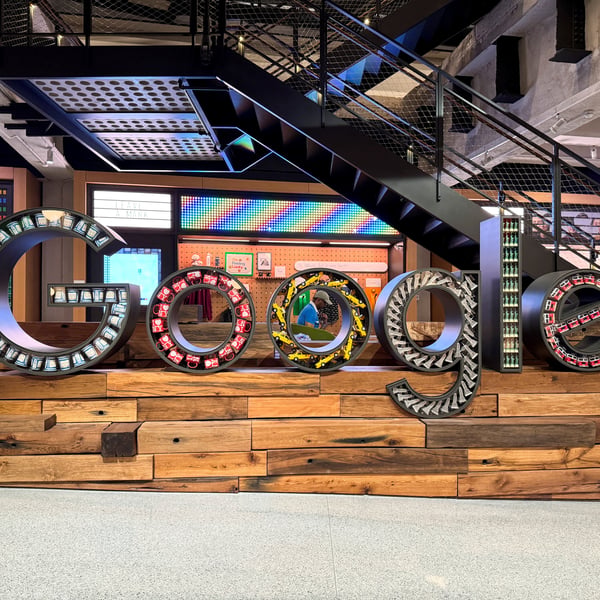 Google headquarters sign with EU flag overlay representing Digital Markets Act fine