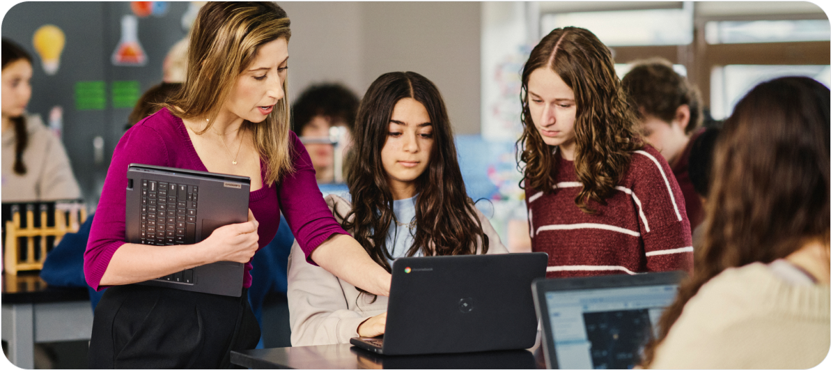 Students collaborate on Google Chromebooks in a school classroom setting