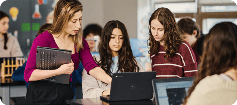 Students collaborate on Google Chromebooks in a school classroom setting