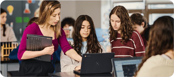 Students collaborate on Google Chromebooks in a school classroom setting