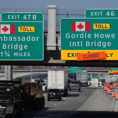 Highway signs marking the Gordie Howe International Bridge connecting Windsor and Detroit