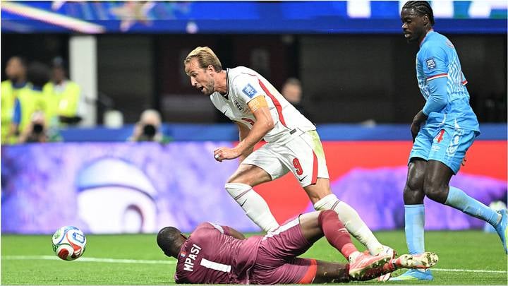 Harry Kane goes down in the box under challenge from DR Congo goalkeeper Lionel Mpasi during England's World Cup round of 32 match