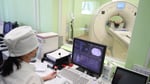 Radiology technician performing CT scan in hospital as hedge funds push healthcare bets to five year high