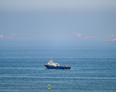 Cargo ships at Khor Fakkan container terminal UAE amid Strait of Hormuz closure 2026