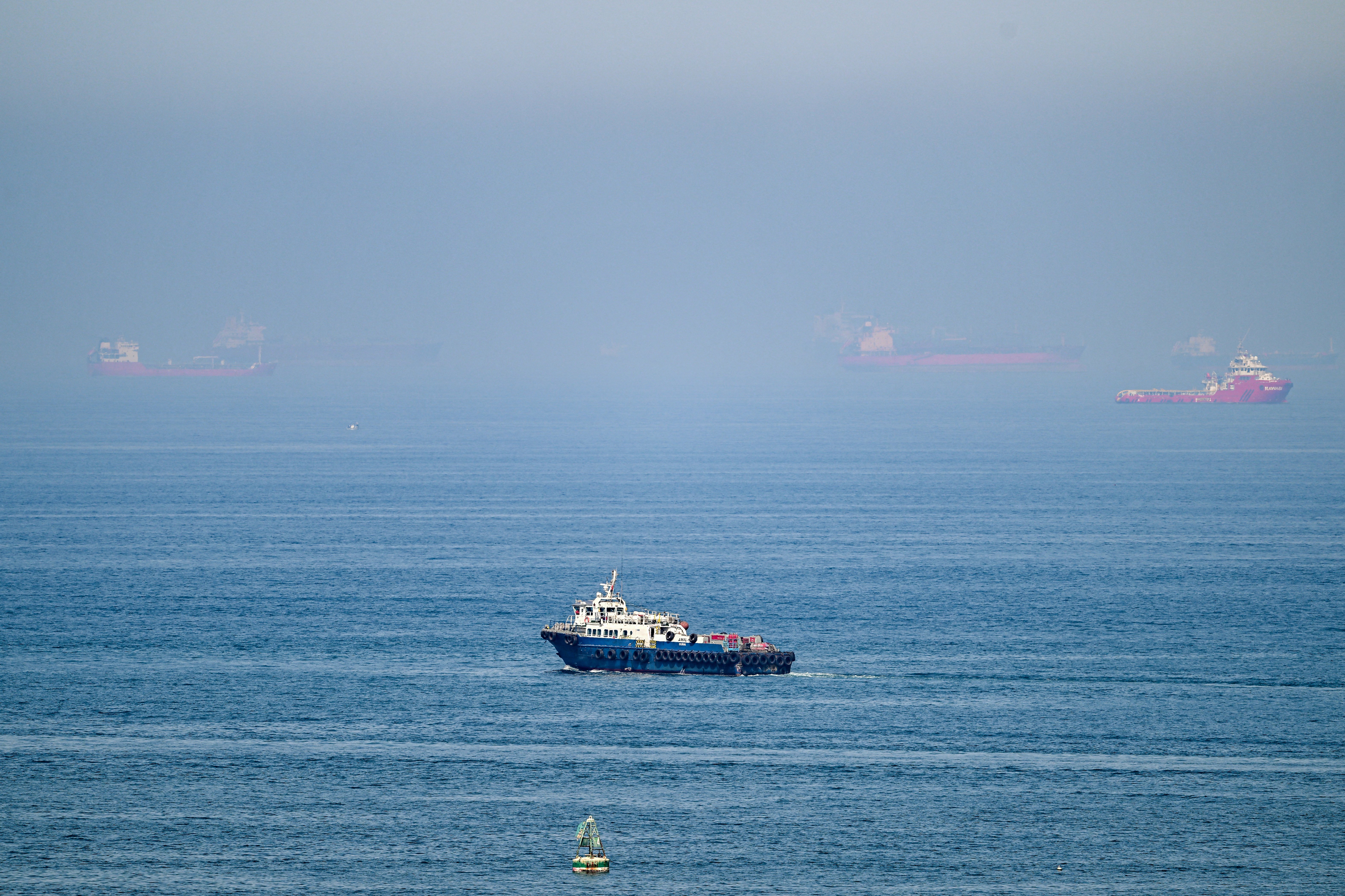 Cargo ships at Khor Fakkan container terminal UAE amid Strait of Hormuz closure 2026