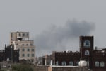 Smoke and damage at Sanaa International Airport after the Yemeni government struck the runway on July 13, 2026, triggering Houthi retaliatory missile and drone strikes against Saudi Arabia's Abha airport