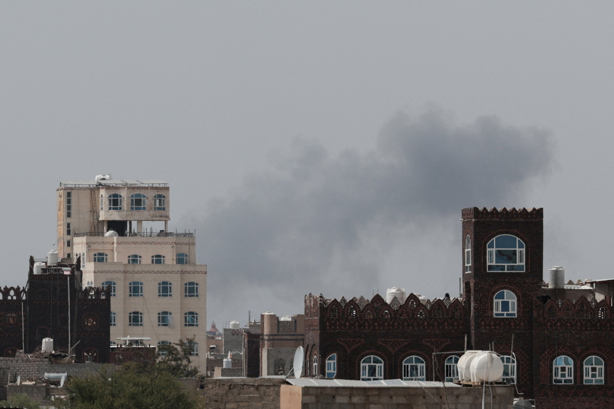 Smoke and damage at Sanaa International Airport after the Yemeni government struck the runway on July 13, 2026, triggering Houthi retaliatory missile and drone strikes against Saudi Arabia's Abha airport