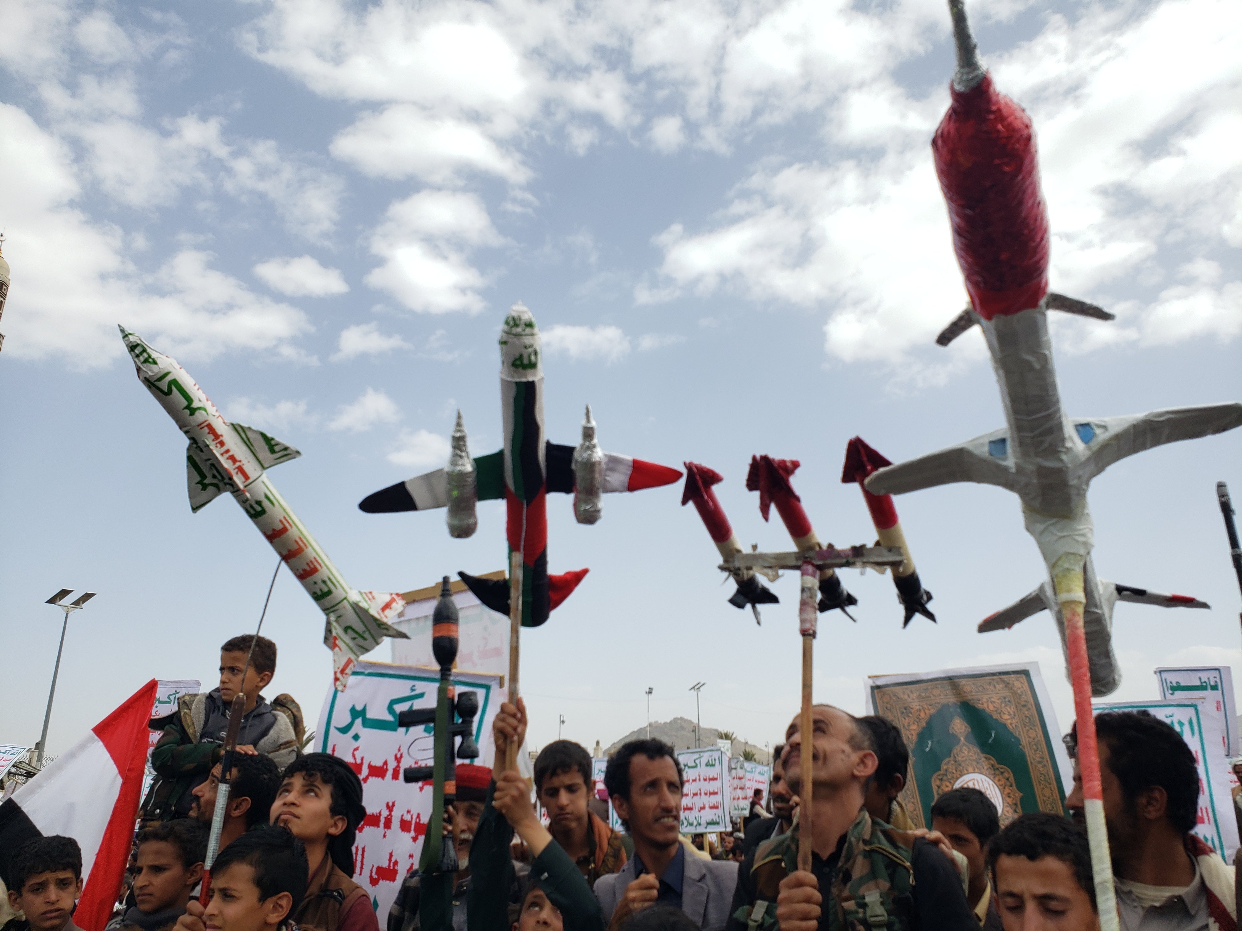 Houthi supporters display mock missiles and drones at a rally in Sanaa, Yemen, reflecting the movement's military capabilities deployed in strikes against Saudi Arabia